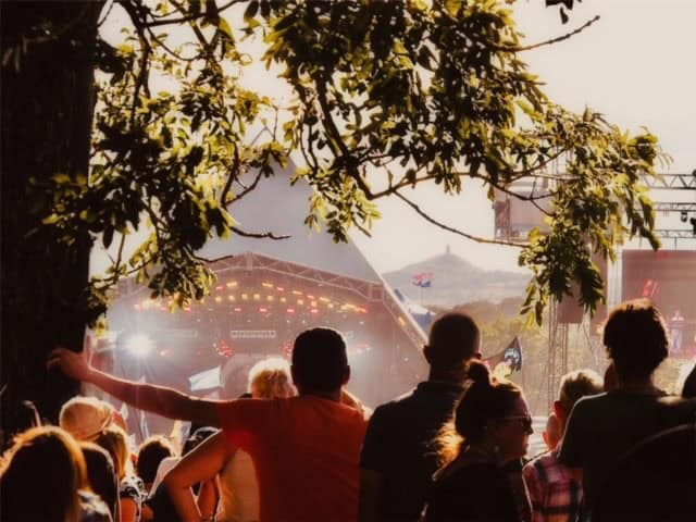 Glasontbury festival-goers on a sunny fesitval day